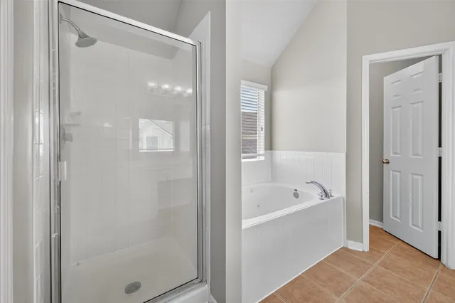 a bathroom with a tub shower and sink