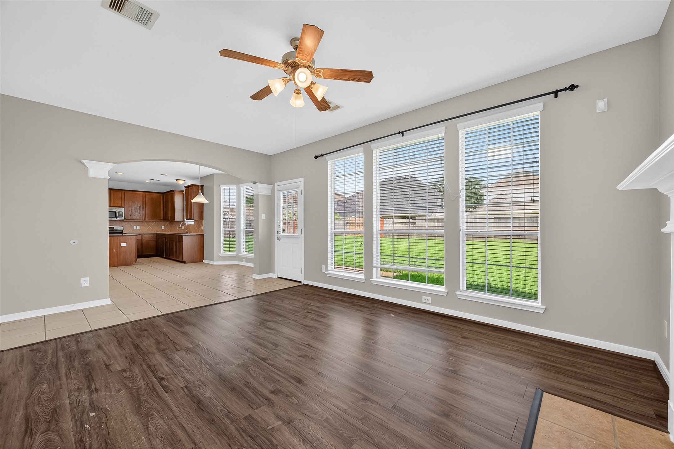 12902 Crystal Reef Court Pearland, TX 77584 - Photo 8 of 35 a view of an empty room with a window and wooden floor