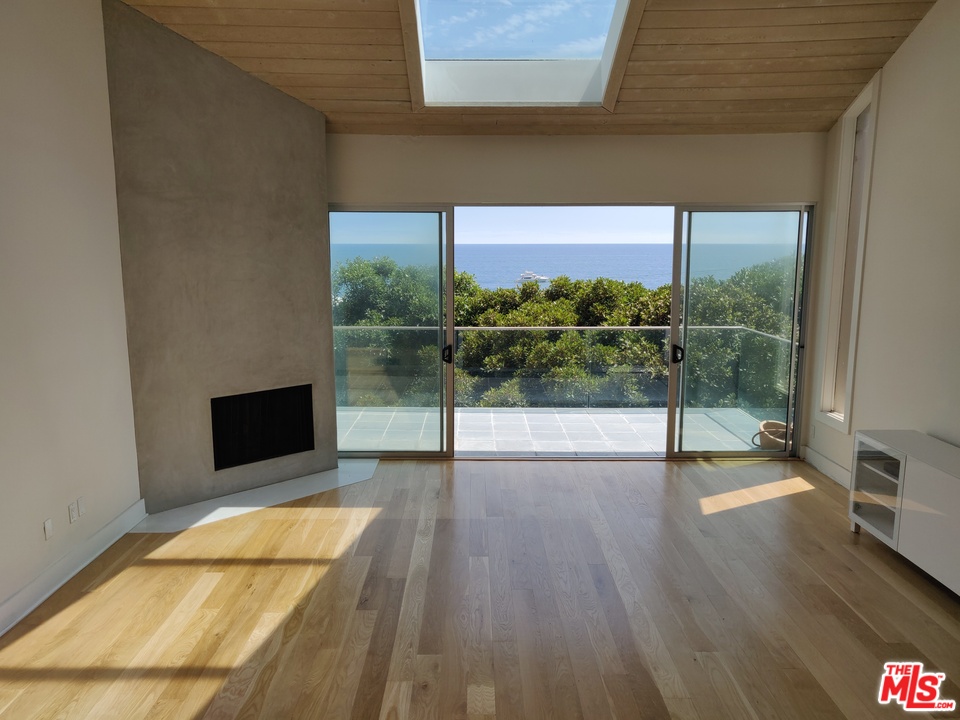 a view of a living room and a floor to ceiling window