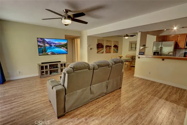 a view of a dining room with furniture and a chandelier fan