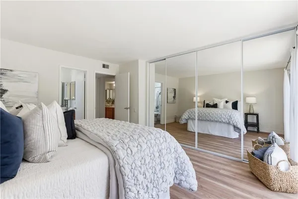 an empty room with wooden floor and a bathroom