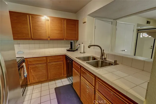 a bedroom with a bed table and a potted plant