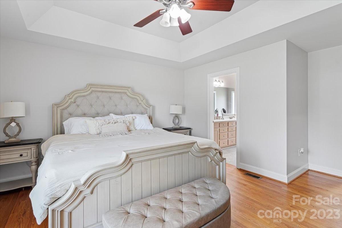 1531 Henry Smith Road Monroe, NC 28110 - Photo 15 of 31 a bedroom with a bed and a chandelier