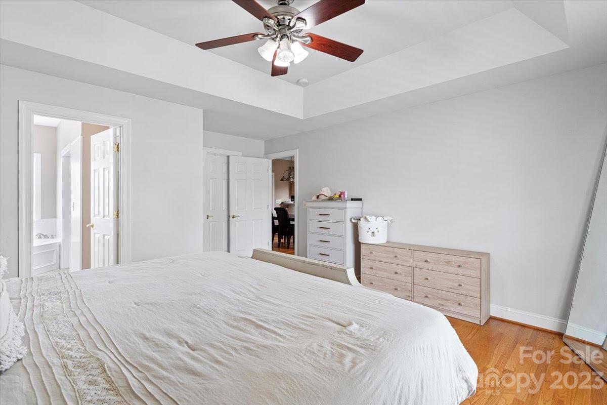 1531 Henry Smith Road Monroe, NC 28110 - Photo 16 of 31 a bedroom with a bed and a chandelier