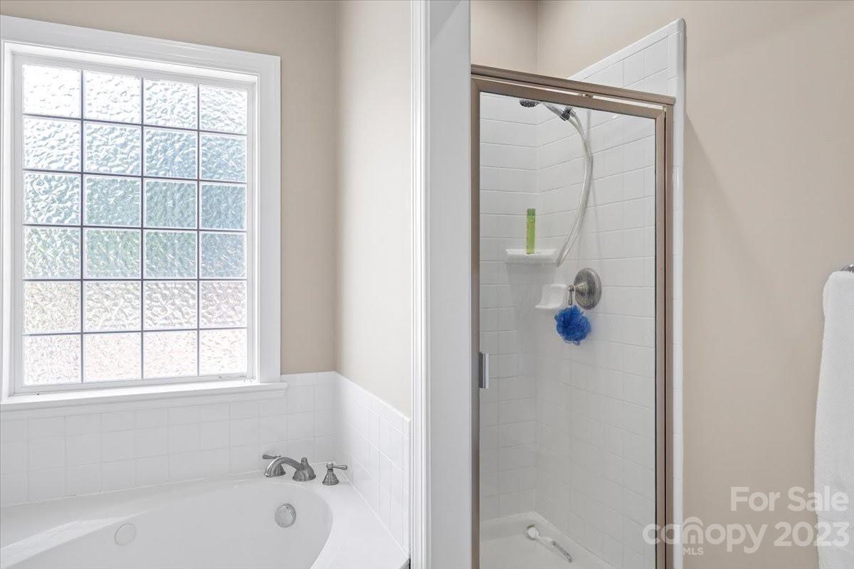 1531 Henry Smith Road Monroe, NC 28110 - Photo 18 of 31 a bathroom with a bathtub and a shower