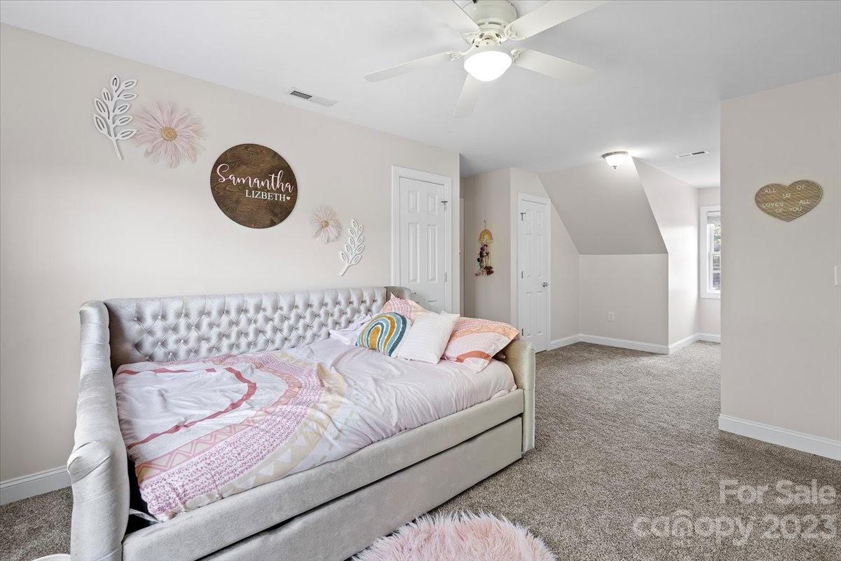 1531 Henry Smith Road Monroe, NC 28110 - Photo 19 of 31 a bedroom with a bed and a chandelier