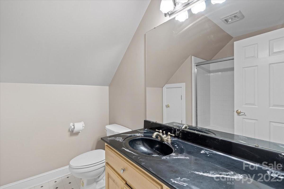 1531 Henry Smith Road Monroe, NC 28110 - Photo 21 of 31 a bathroom with a granite countertop sink and a toilet