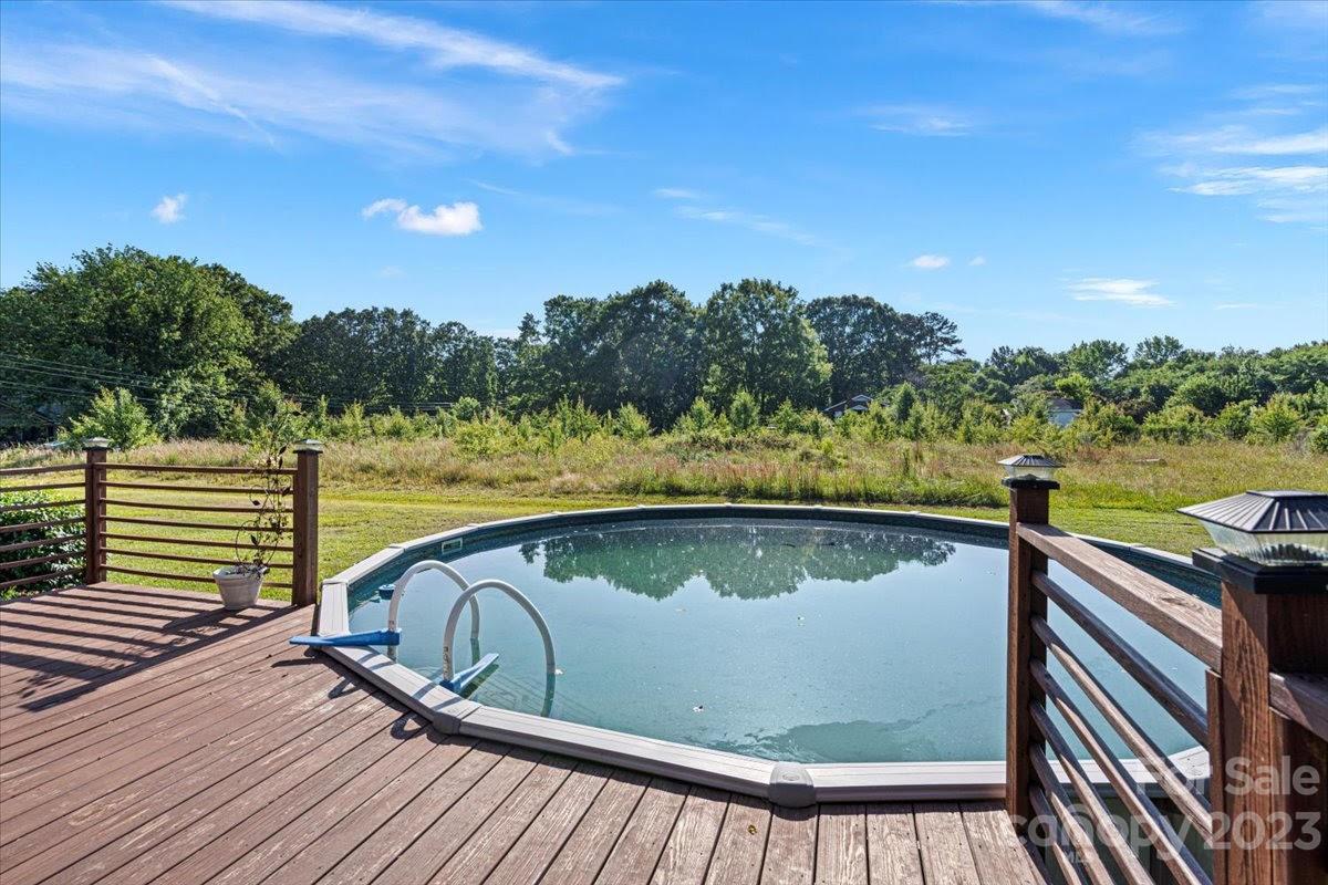 1531 Henry Smith Road Monroe, NC 28110 - Photo 27 of 31 a view of swimming pool with lake and mountain in the back