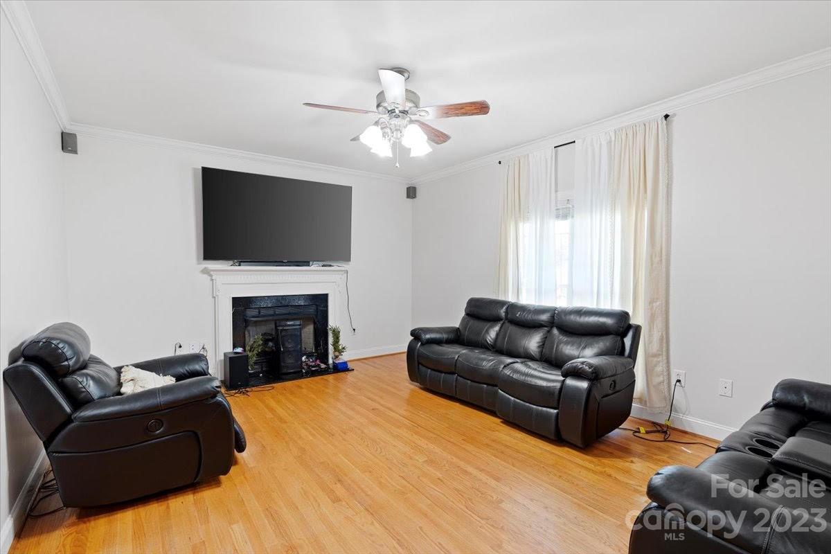 1531 Henry Smith Road Monroe, NC 28110 - Photo 5 of 31 a living room with furniture a fireplace and a flat screen tv