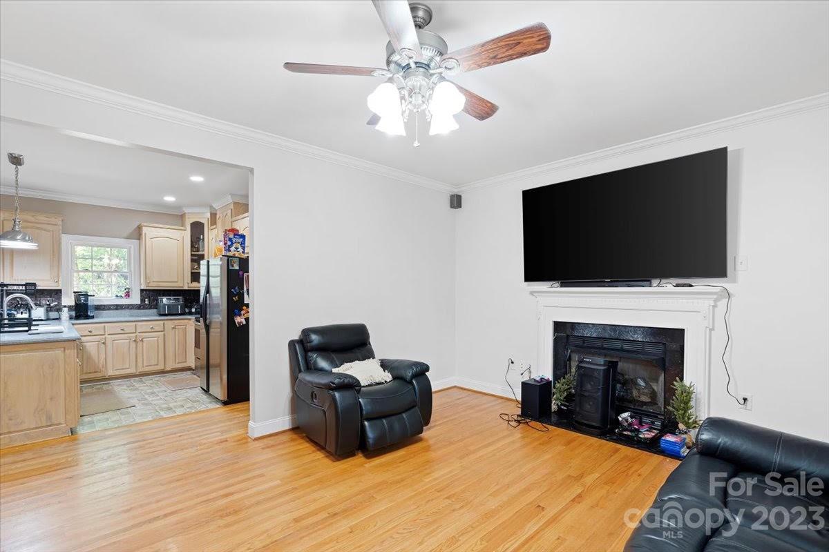 1531 Henry Smith Road Monroe, NC 28110 - Photo 6 of 31 a living room with furniture a flat screen tv and a fireplace