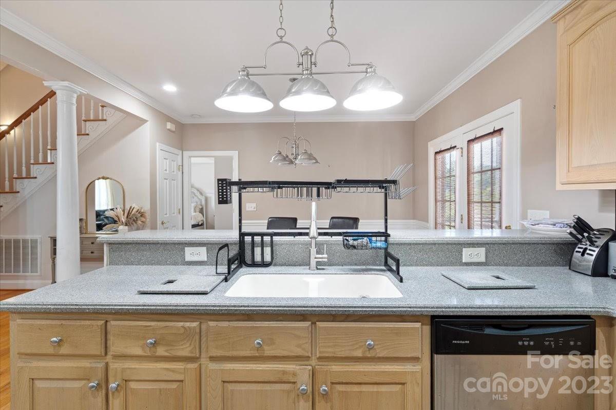 1531 Henry Smith Road Monroe, NC 28110 - Photo 8 of 31 a kitchen with cabinets and chandelier