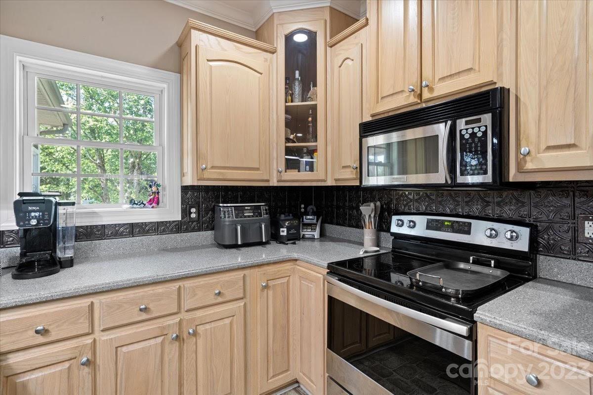 1531 Henry Smith Road Monroe, NC 28110 - Photo 10 of 31 a kitchen with granite countertop a stove a sink and cabinets