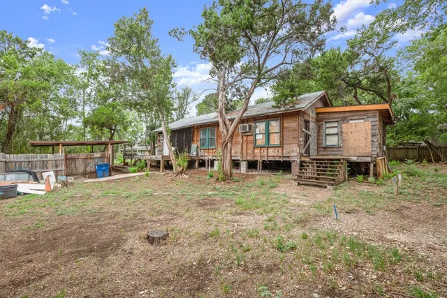 a view of backyard with swings and slides