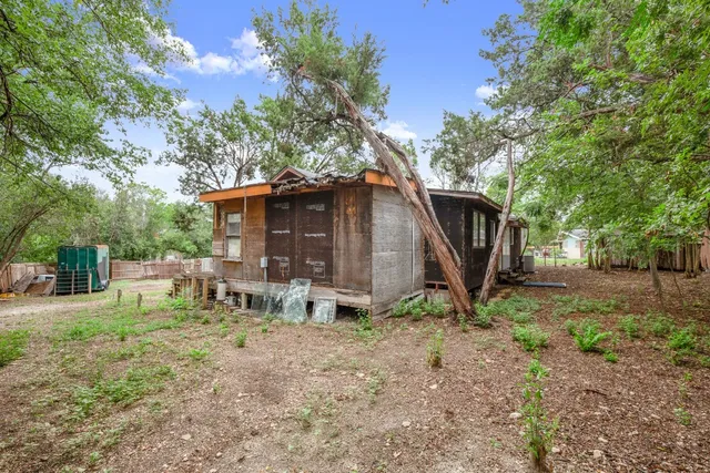 a backyard of a house with table and chairs