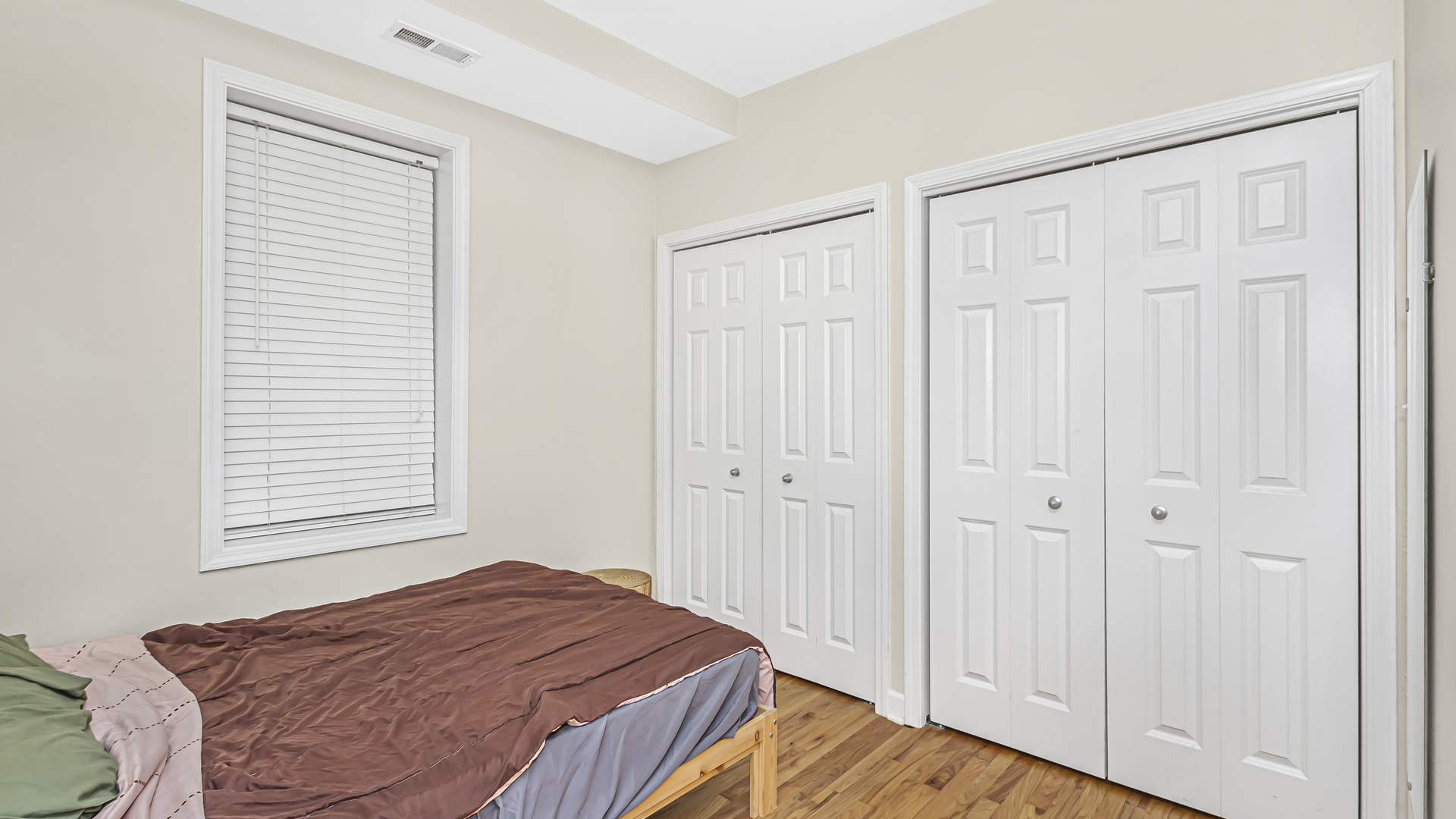 1430 West Chestnut Street, Unit 1 Chicago, IL 60642 - Photo 13 of 14 a bedroom with a bed and a window