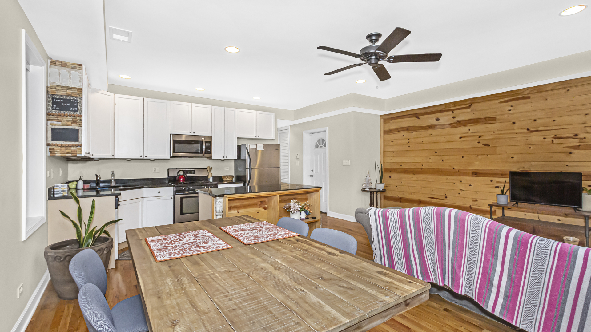 1430 West Chestnut Street, Unit 1 Chicago, IL 60642 - Photo 6 of 14 a living room with stainless steel appliances furniture and a flat screen tv