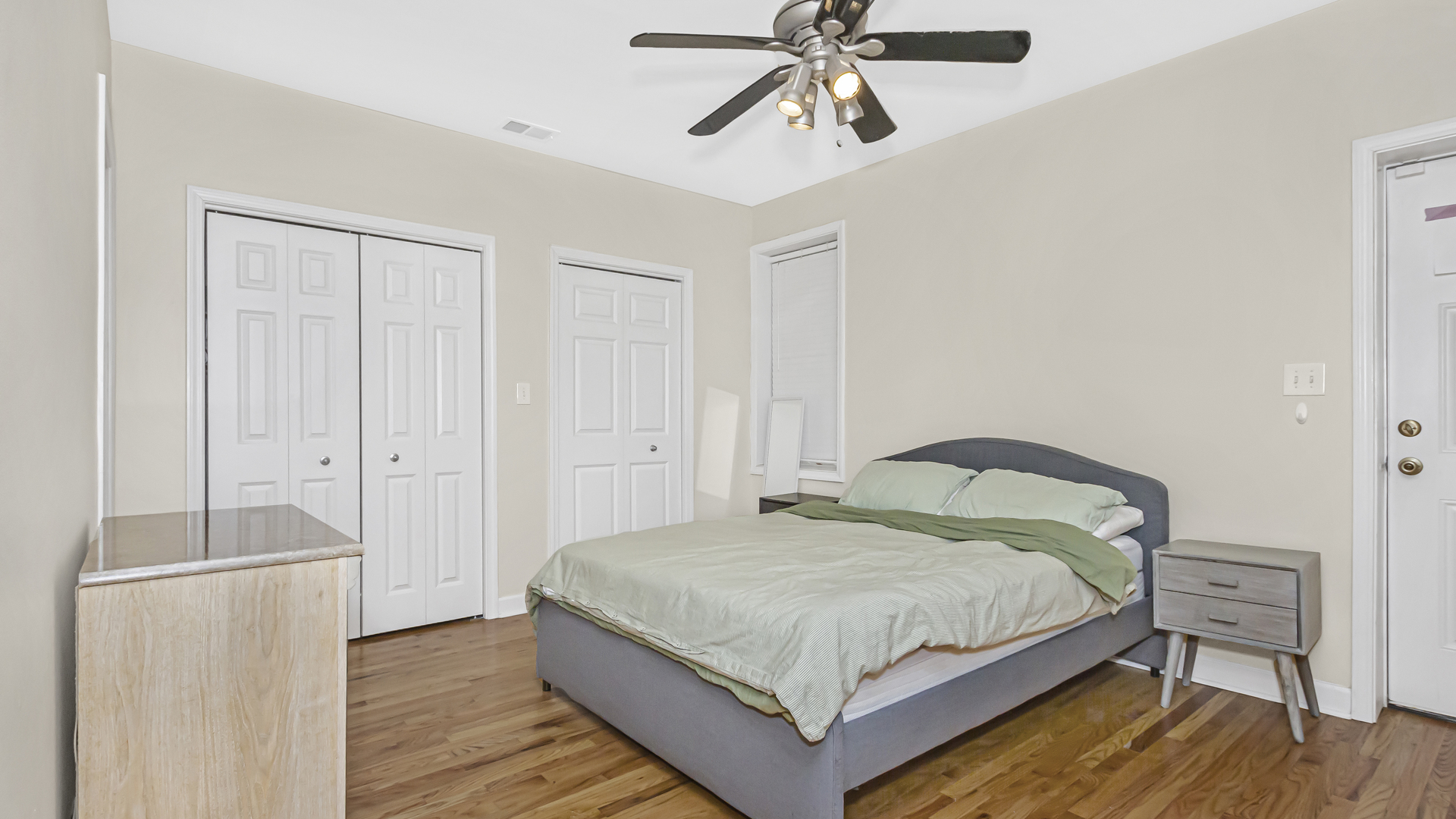 1430 West Chestnut Street, Unit 1 Chicago, IL 60642 - Photo 9 of 14 a bedroom with a bed and a chandelier
