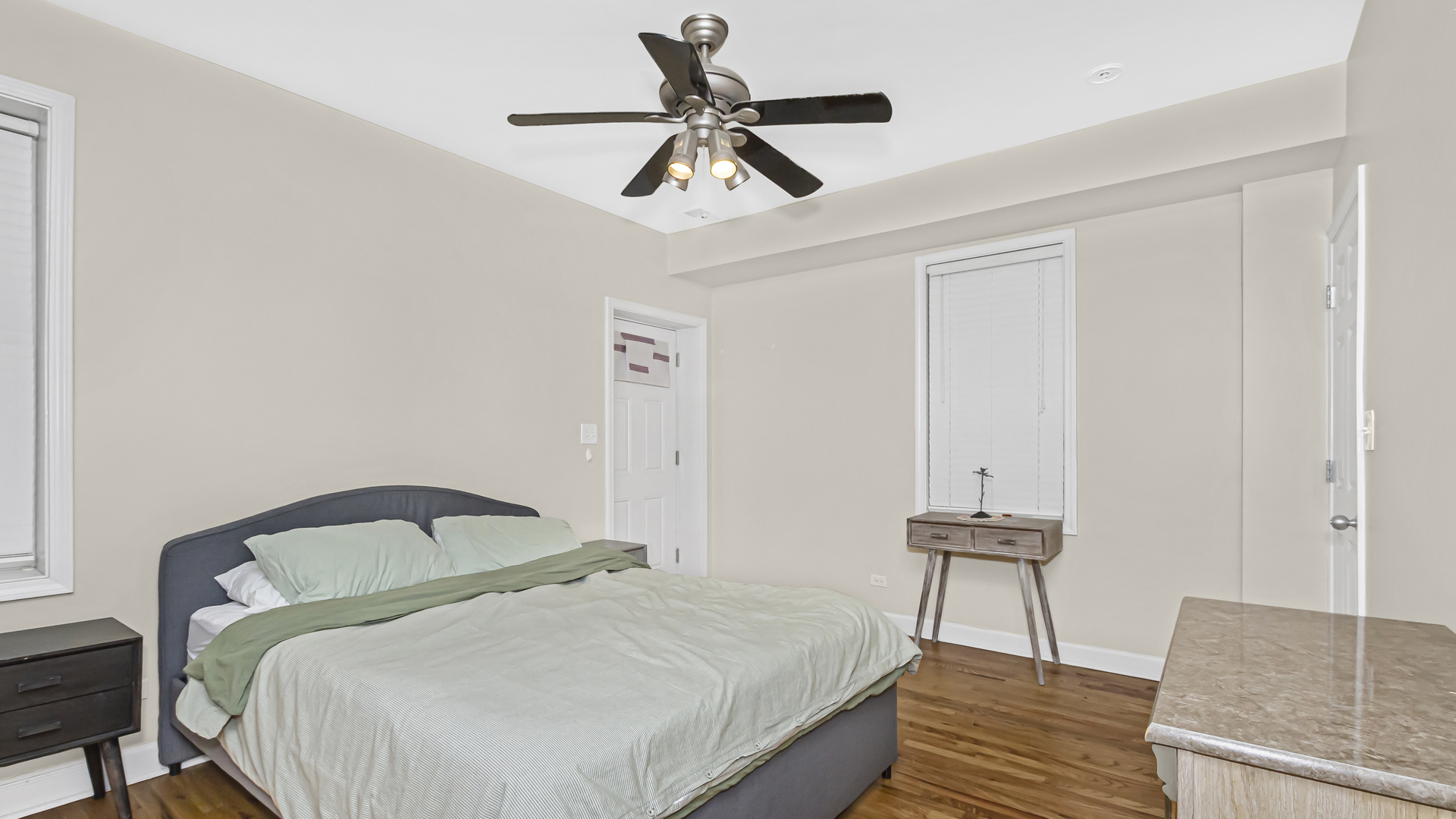 1430 West Chestnut Street, Unit 1 Chicago, IL 60642 - Photo 10 of 14 a bedroom with a bed and a chandelier