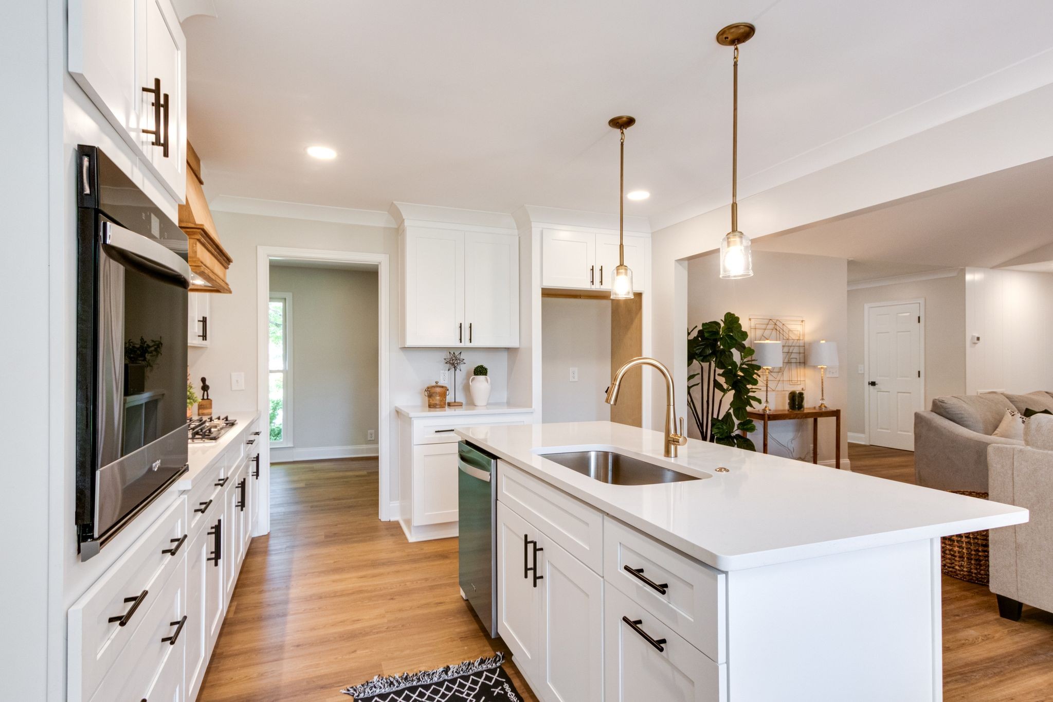 2302 Surrey Drive Murfreesboro, TN 37129 - Photo 9 of 26 a kitchen with stainless steel appliances kitchen island granite countertop a sink a microwave oven a refrigerator and white cabinets