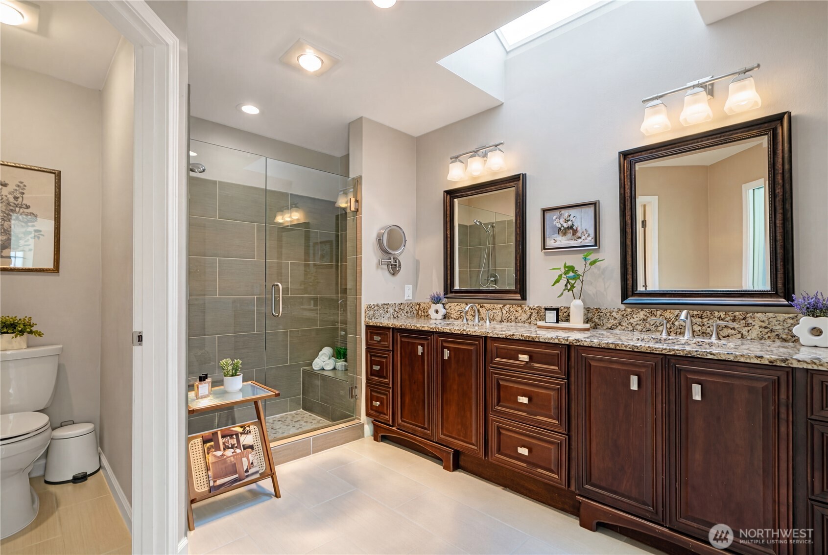 4016 243rd Place Southeast Issaquah, WA 98029 - Photo 17 of 35 a spacious bathroom with a granite countertop sink a toilet a mirror and shower