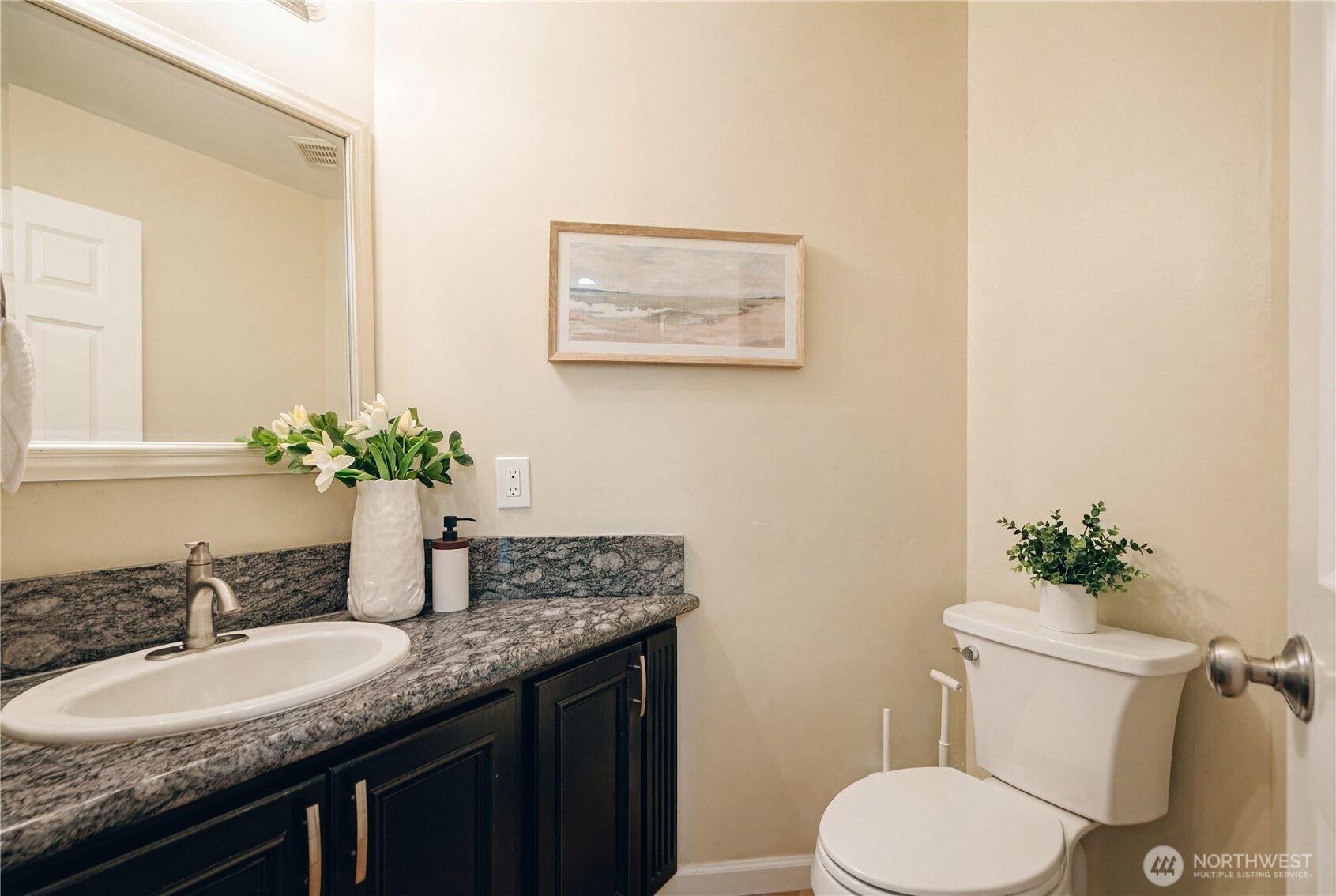 4016 243rd Place Southeast Issaquah, WA 98029 - Photo 22 of 35 a bathroom with a granite countertop toilet sink and mirror