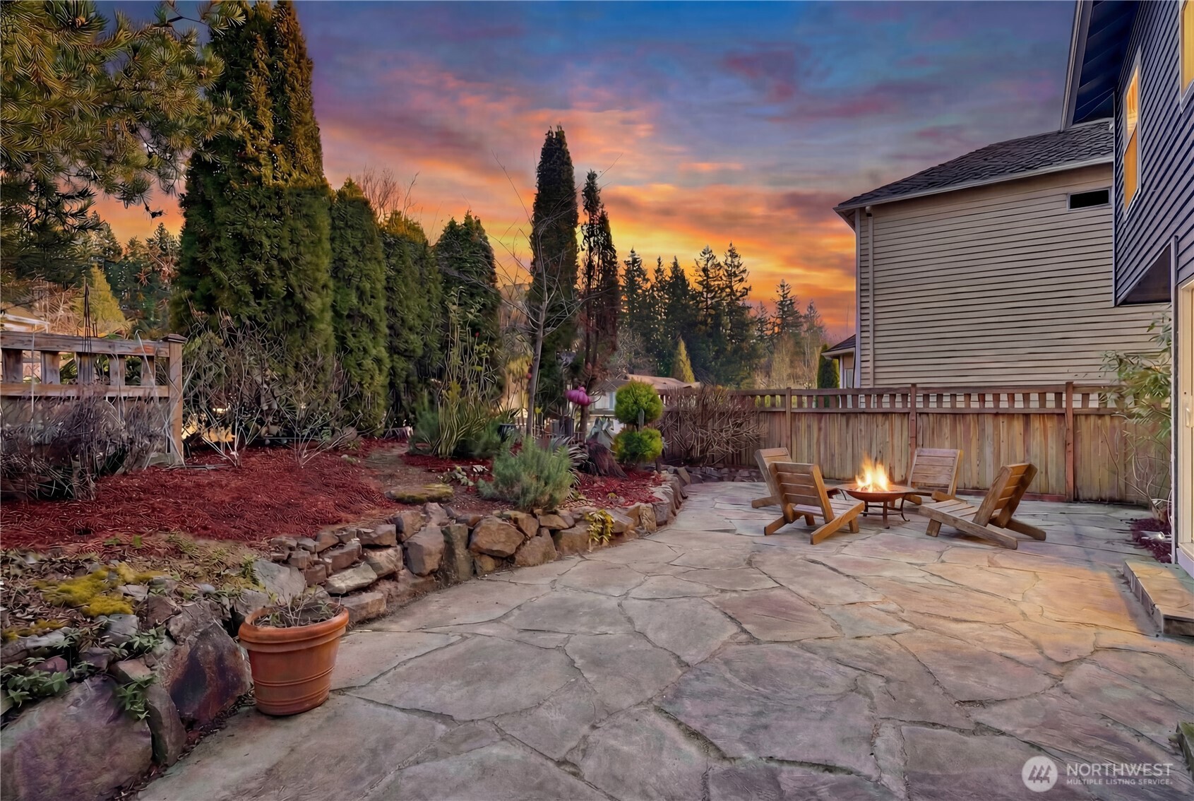 4016 243rd Place Southeast Issaquah, WA 98029 - Photo 23 of 35 a view of a patio with a table and chairs and potted plants
