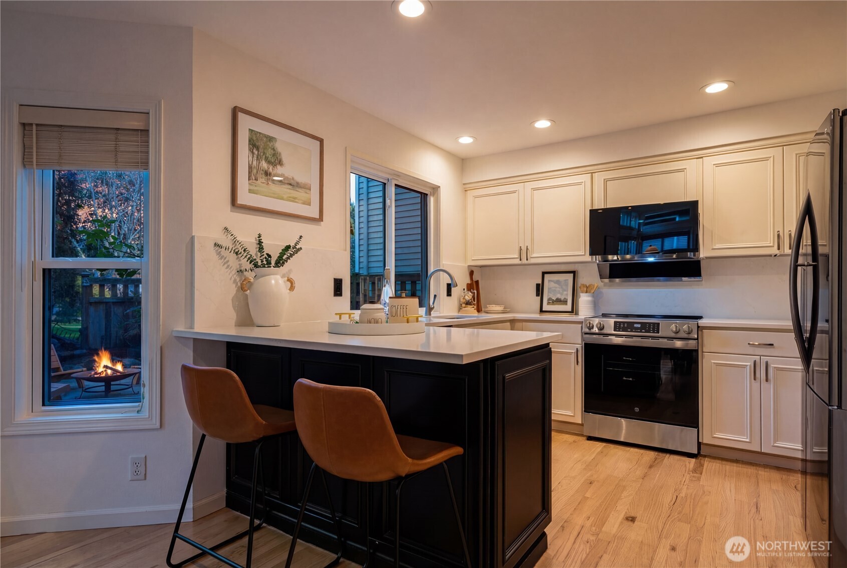 4016 243rd Place Southeast Issaquah, WA 98029 - Photo 31 of 35 a kitchen with stainless steel appliances granite countertop a stove a sink dishwasher a refrigerator and a dining table with wooden floor