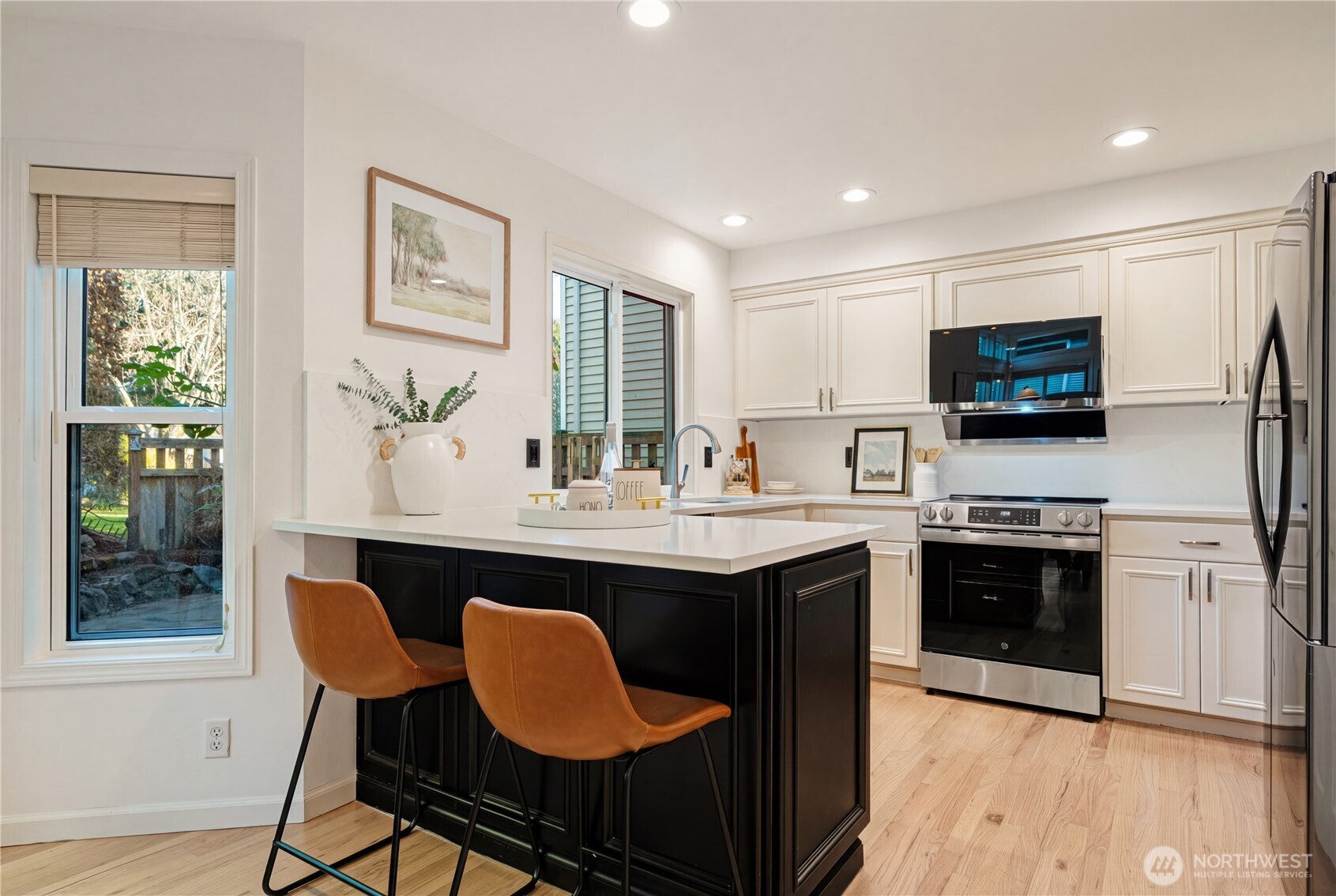 4016 243rd Place Southeast Issaquah, WA 98029 - Photo 9 of 35 a kitchen with stainless steel appliances granite countertop a kitchen island hardwood floor sink stove dining table and chairs