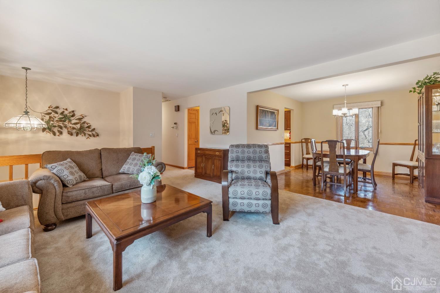 53 Bristol Road Piscataway, NJ 08854 - Photo 7 of 33 a living room with furniture and a dining table with wooden floor