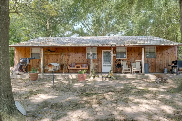 a view of a house with backyard porch and sitting area