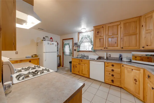 a kitchen with refrigerator and cabinets