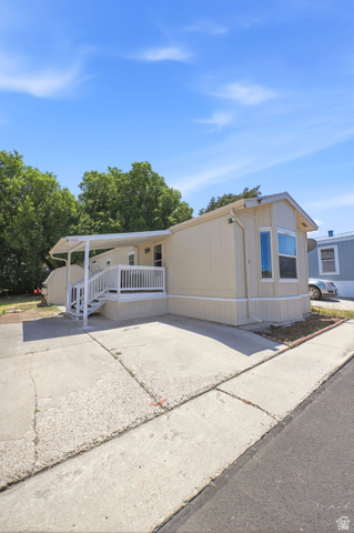 1525 South 400 East, Unit 13 Springville, UT 84663 - Photo 7 of 32 Light-toned exterior with a covered porch and white railing