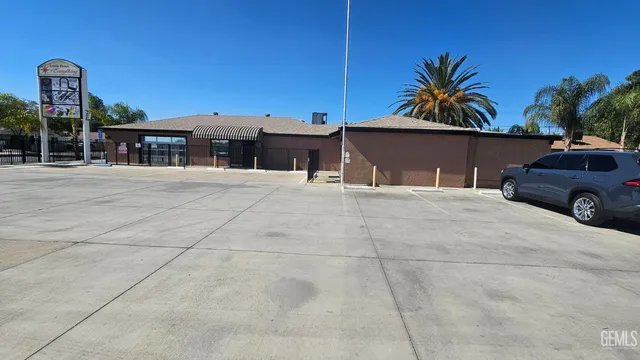 a view of house with outdoor space and palm tree