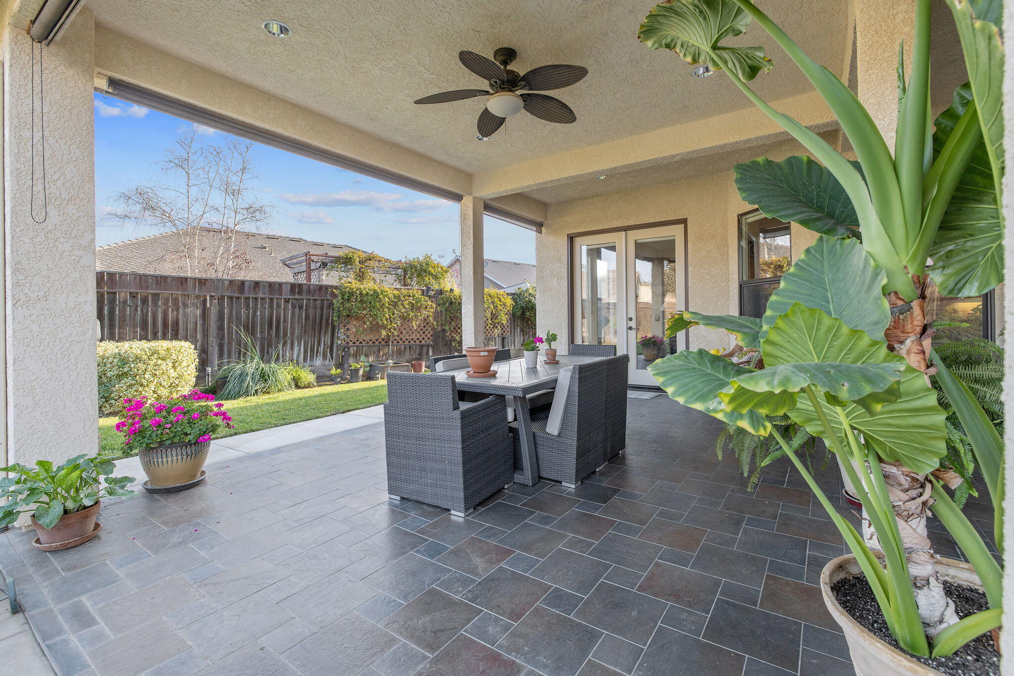 729 St Thomas Court Exeter, CA 93221 - Photo 43 of 66 a view of a patio with a table and chairs potted plants with wooden floor