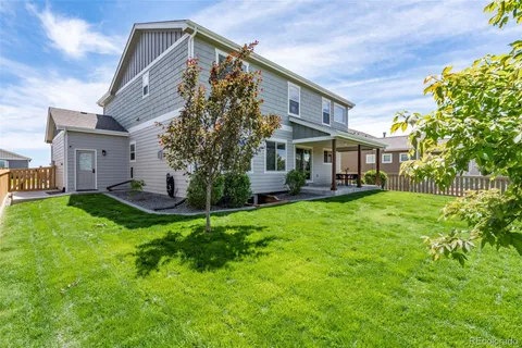 a view of a house with a yard and sitting area