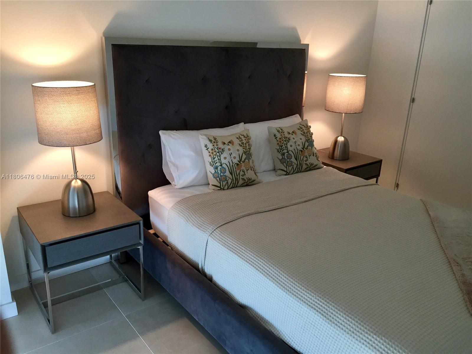 401 North Birch Road, Unit 505 Fort Lauderdale, FL 33304 - Photo 12 of 29 a bedroom with a lamp beds and a lamp