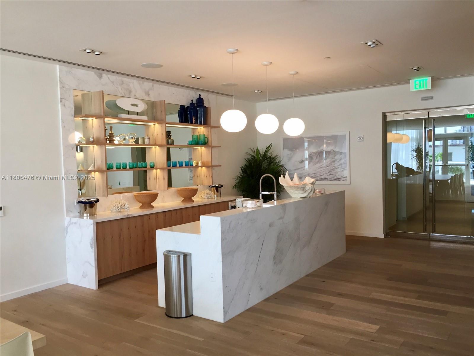 401 North Birch Road, Unit 505 Fort Lauderdale, FL 33304 - Photo 19 of 29 a large kitchen with kitchen island a sink stainless steel appliances and cabinets