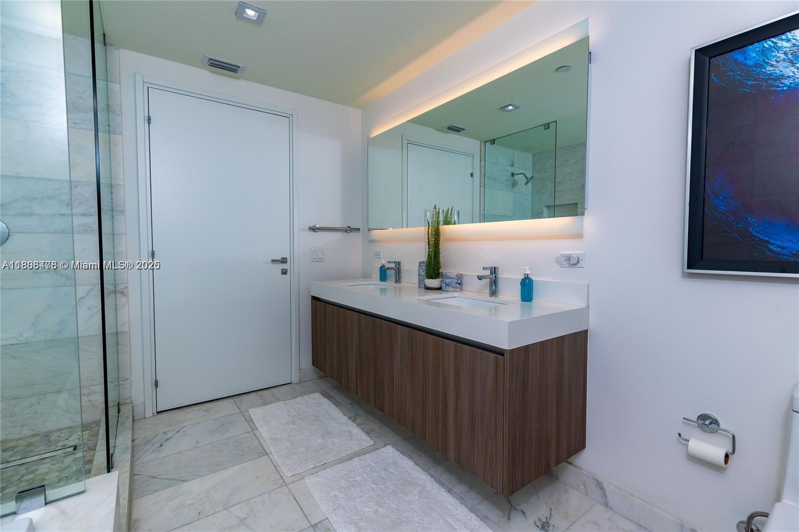 401 North Birch Road, Unit 505 Fort Lauderdale, FL 33304 - Photo 27 of 29 a bathroom with a sink vanity and mirror