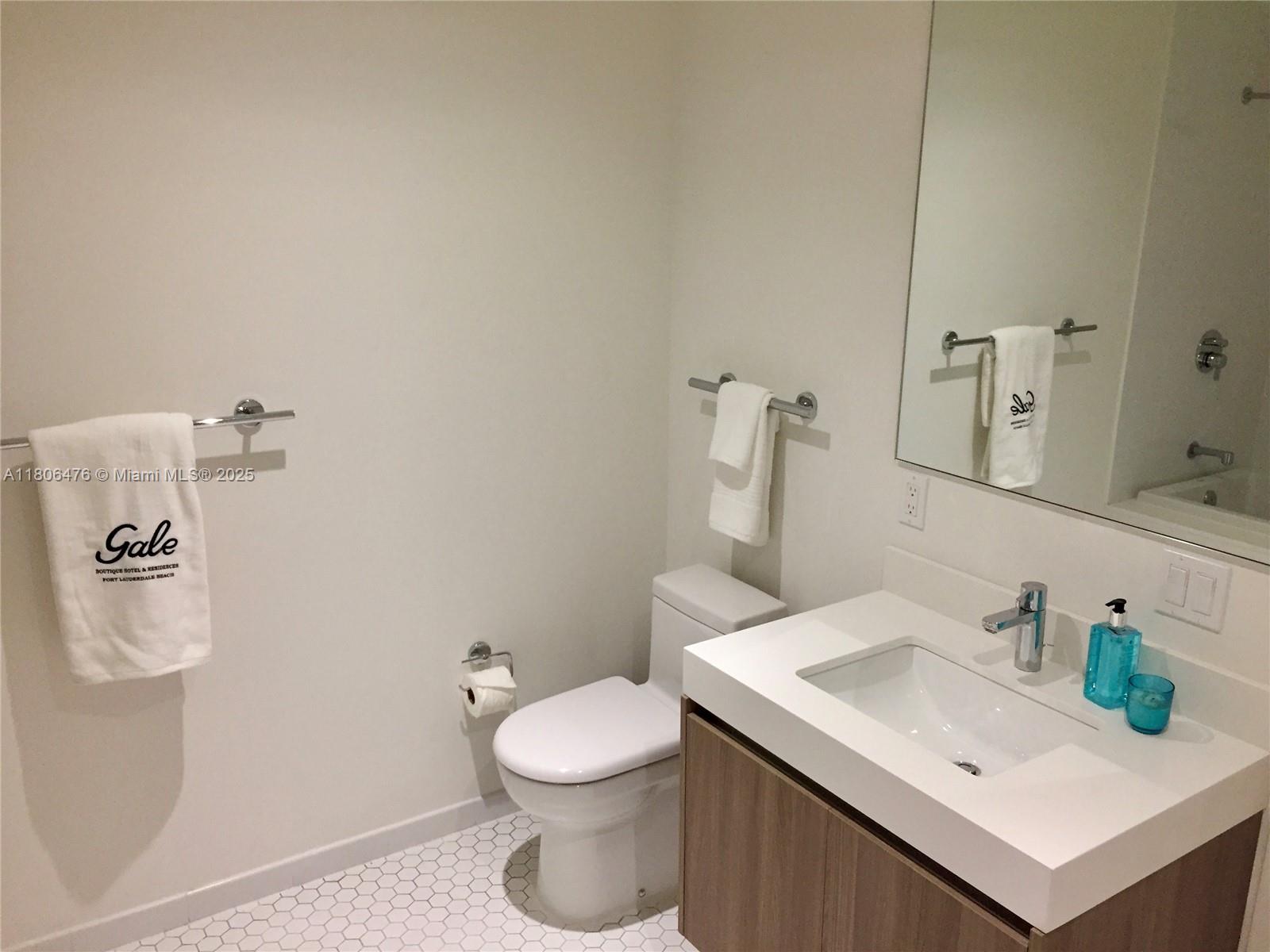 401 North Birch Road, Unit 505 Fort Lauderdale, FL 33304 - Photo 9 of 29 a bathroom with a sink a toilet and mirror