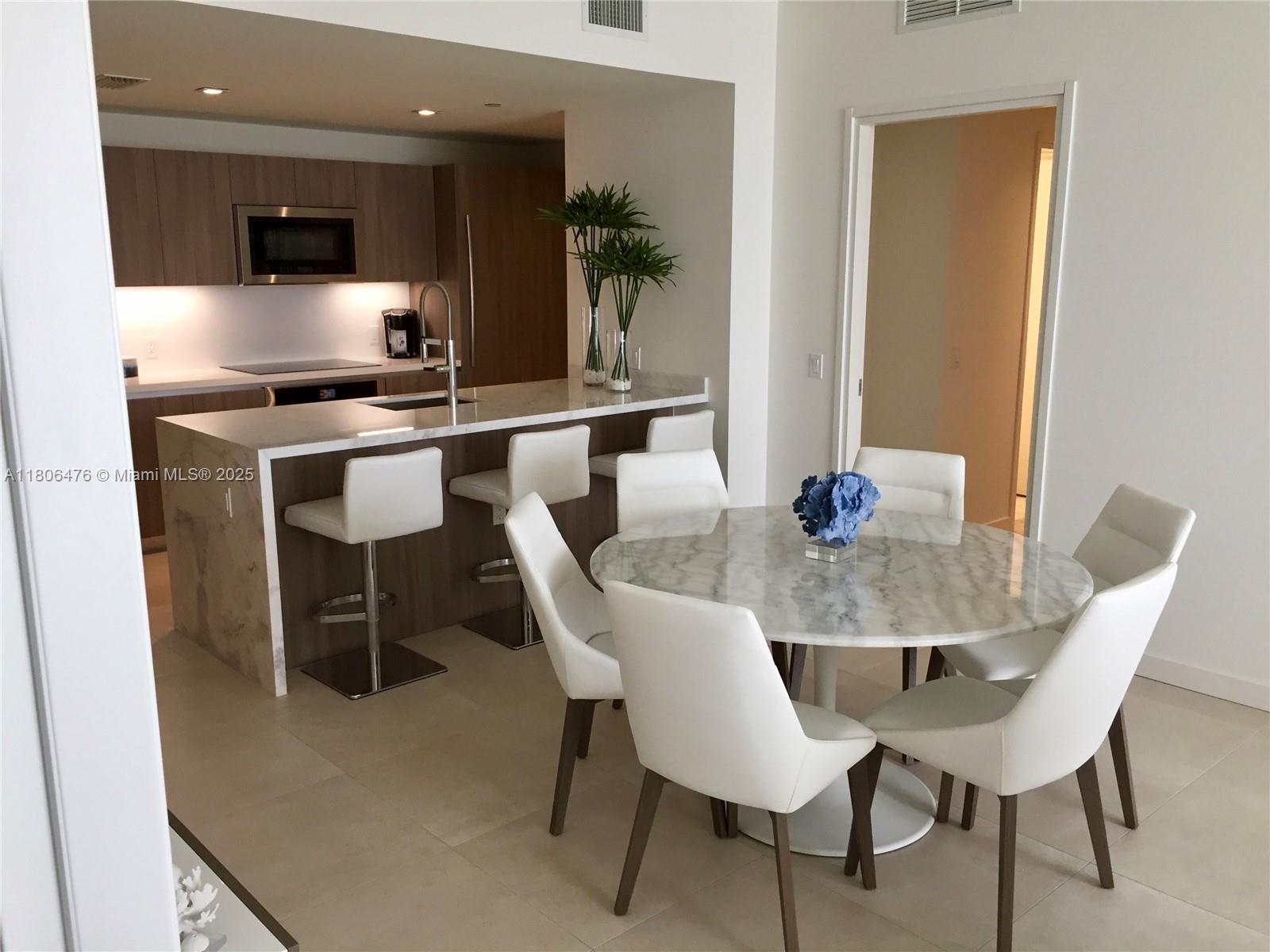 401 North Birch Road, Unit 505 Fort Lauderdale, FL 33304 - Photo 10 of 29 a dining room with furniture and wooden floor