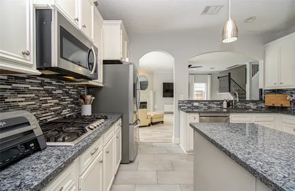 a kitchen with stainless steel appliances granite countertop a stove and a sink