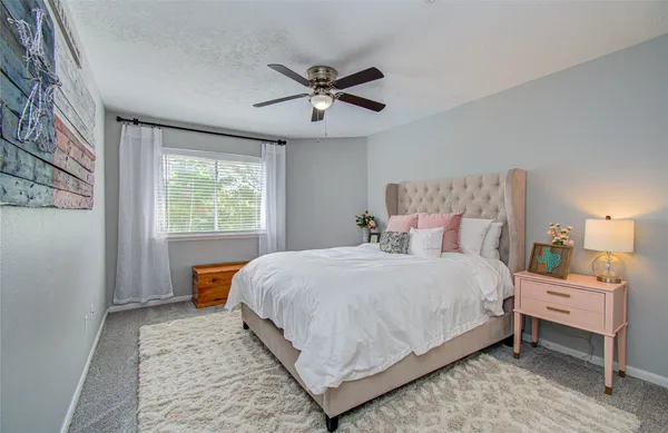 a bedroom with a large bed and a window