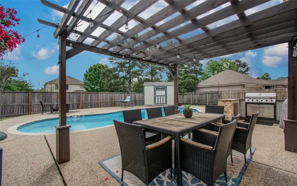 a view of a patio with a table and chairs