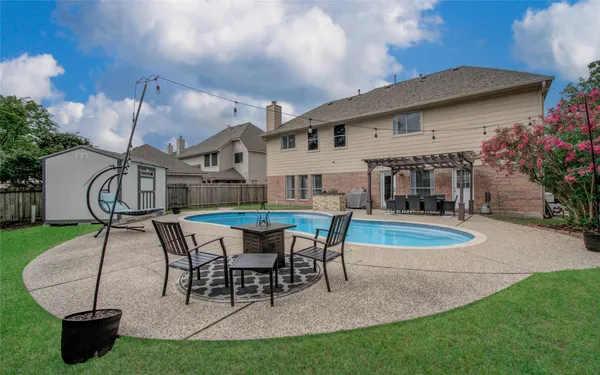 a view of a house with backyard porch and sitting area