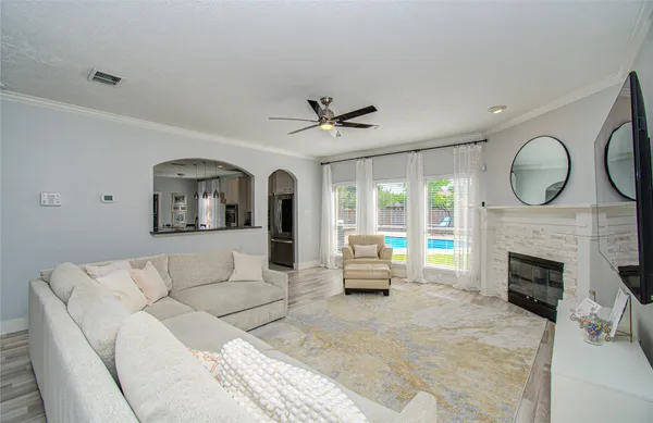 a living room with furniture a fireplace and a large window