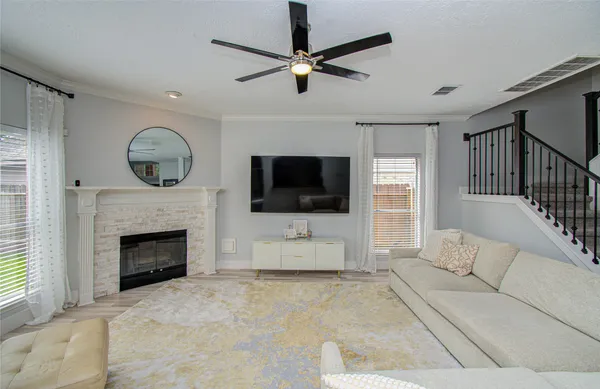 a living room with furniture a fireplace and a flat screen tv