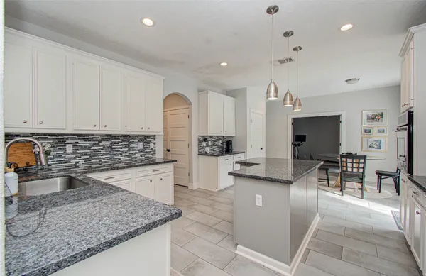 a kitchen with lots of counter top space and stainless steel appliances
