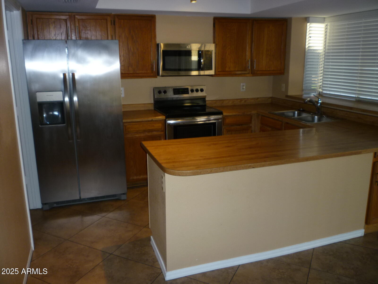 4216 West Willow Avenue Phoenix, AZ 85029 - Photo 4 of 14 a kitchen with stainless steel appliances granite countertop a refrigerator a stove a sink and a microwave