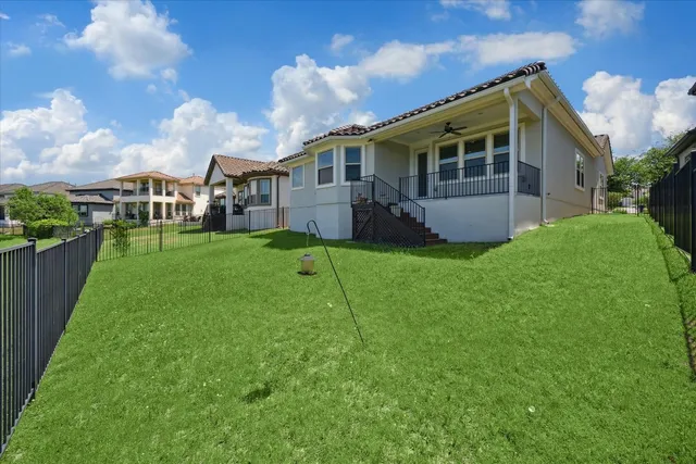 a view of a house with backyard and sitting area