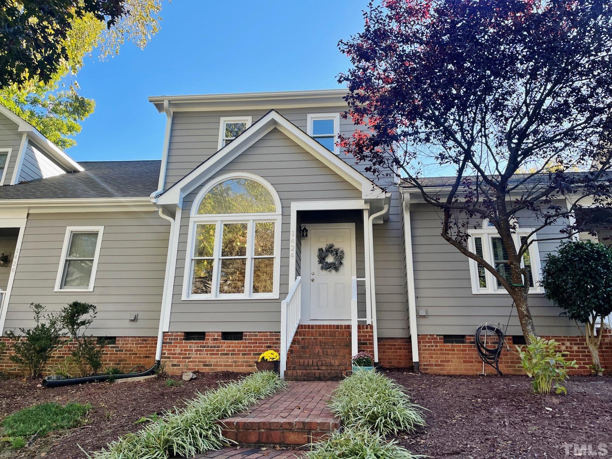 a front view of a house with garden